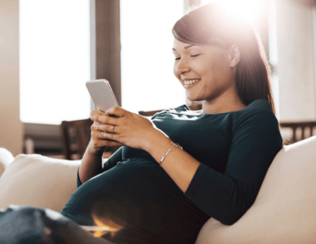 Pregnant Mother using mobile device with Babyscripts Mobile Application Pregnant Mother using mobile device with Babyscripts Mobile Application
