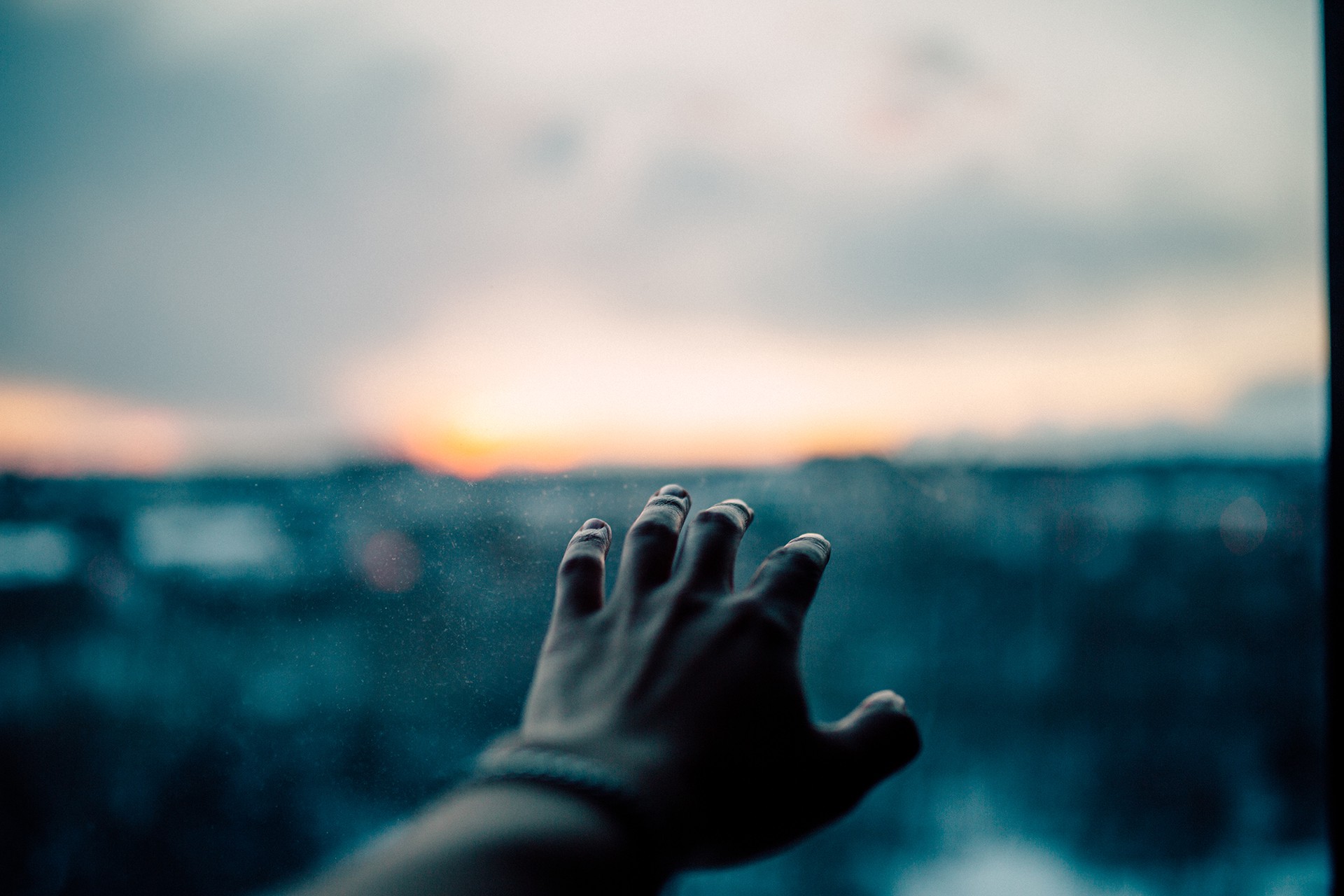 Hand reaching towards the horizon