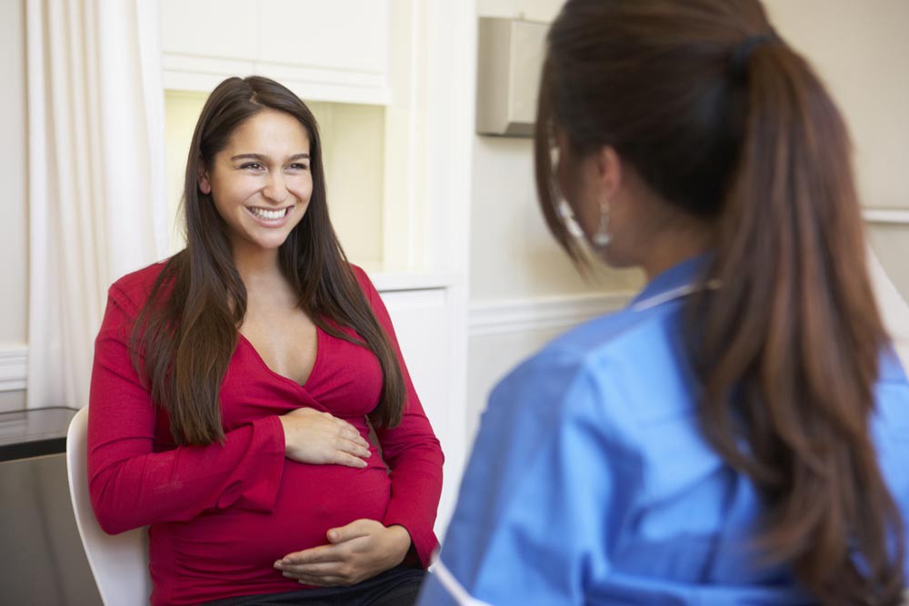 Pregnant woman and social worker