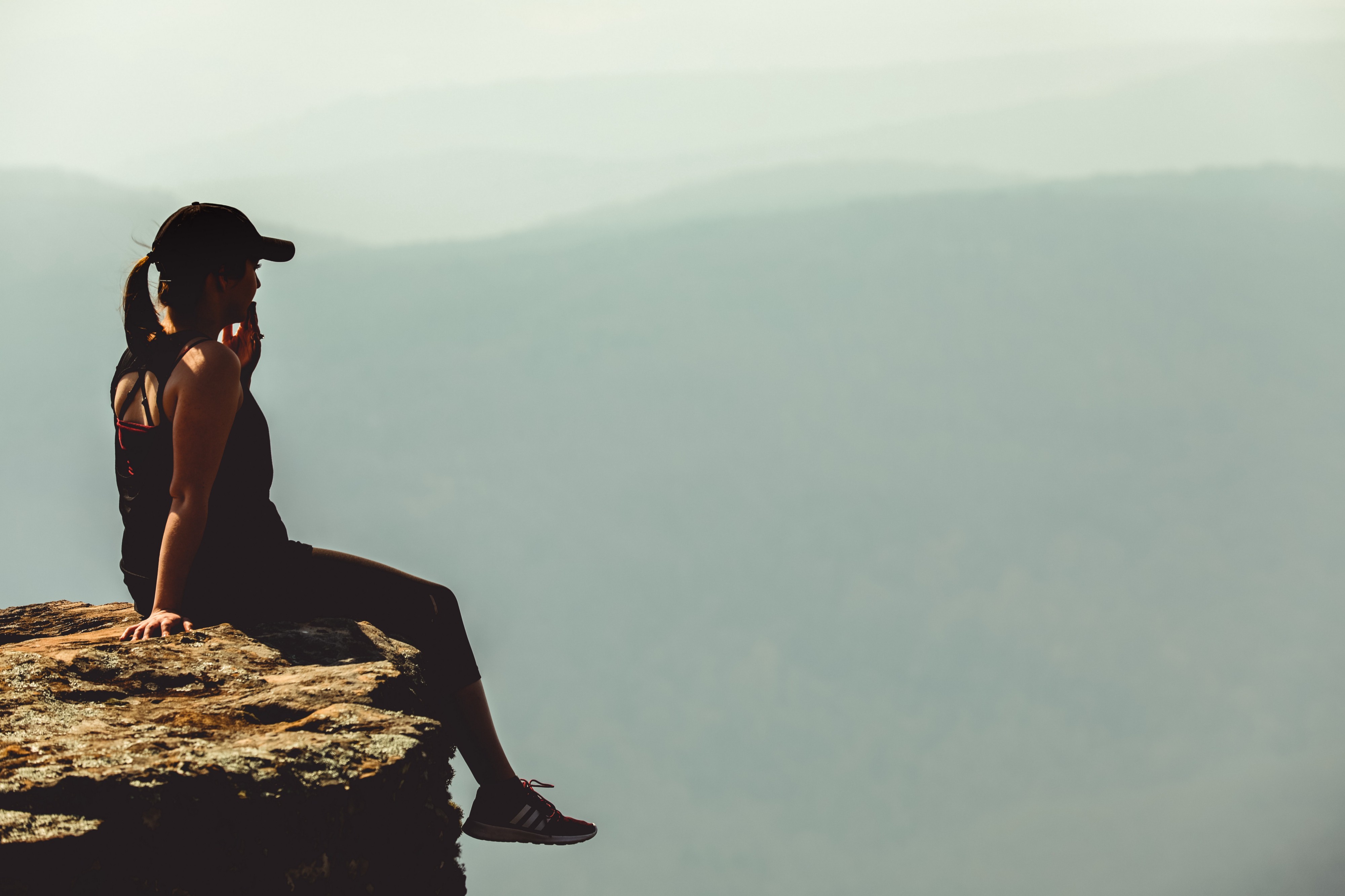 woman sitting on a cliff