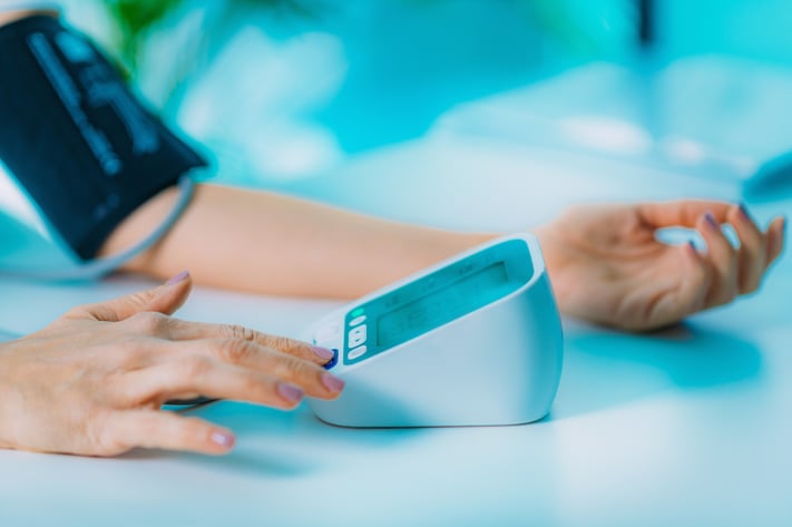 patient using blood pressure cuff