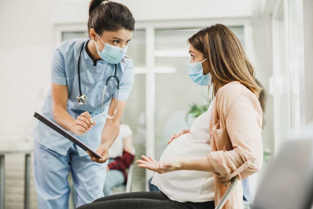 pregnant-woman-talking-to-nurse-during-coronavirus-2021-09-03-12-29-51-utc