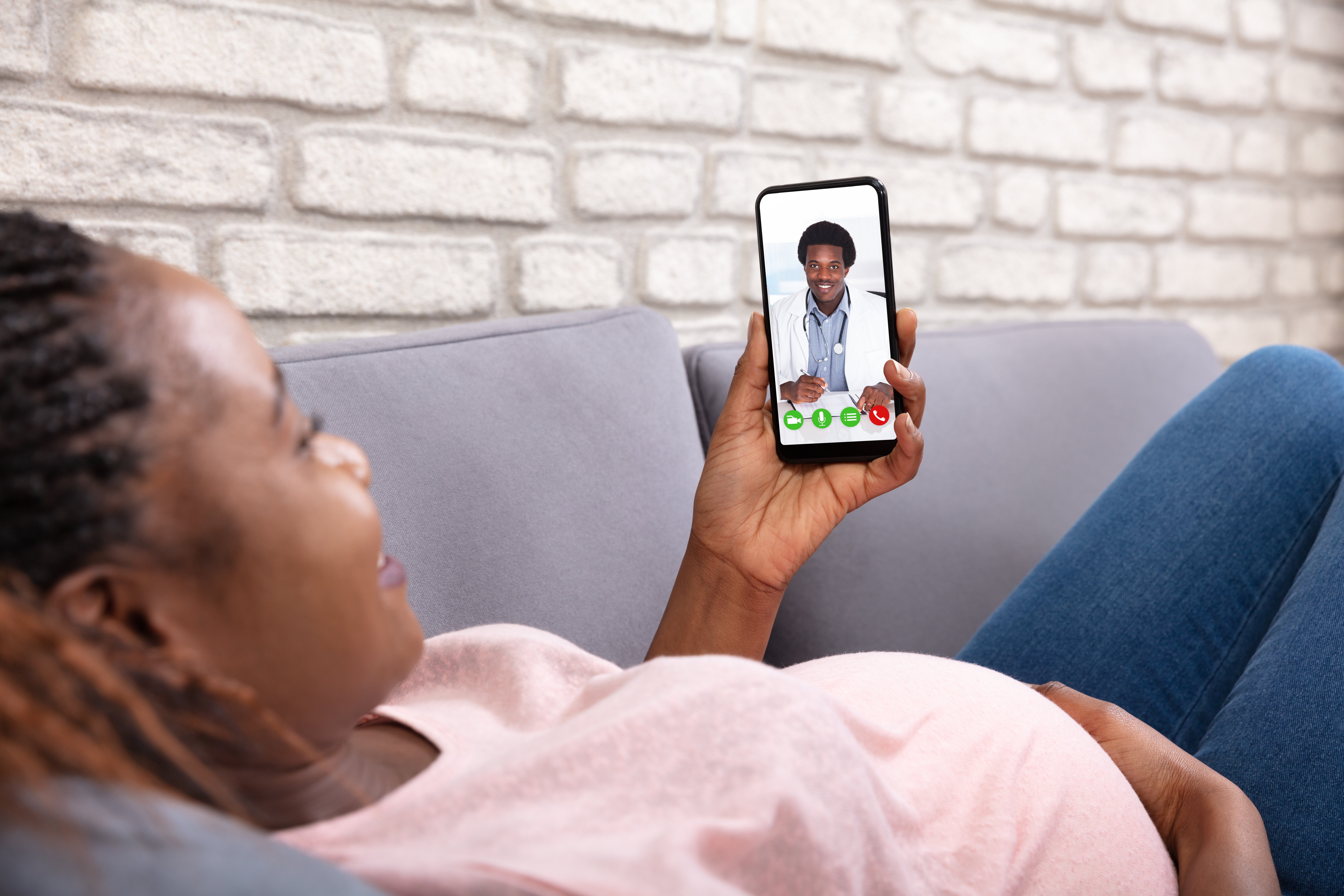 Pregnant woman using telemedicine app